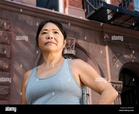 a 65 year old woman of japanese descent wearing workout clothing in new