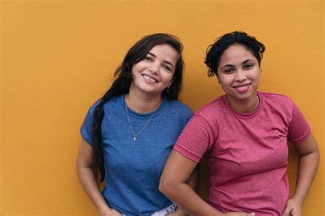 Premium Photo Latin Lesbian Couple Standing On A Yellow Wall Lgbt