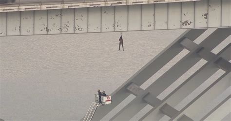 man dangling  bridge rescued  houston