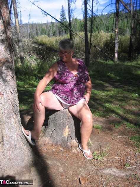 fat granny girdle goddess loses her purple outfit in the woods and poses nude
