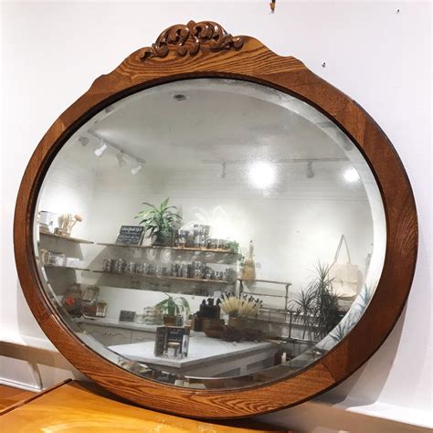 antique wooden oval mirror  beveled edges  pale blue dot