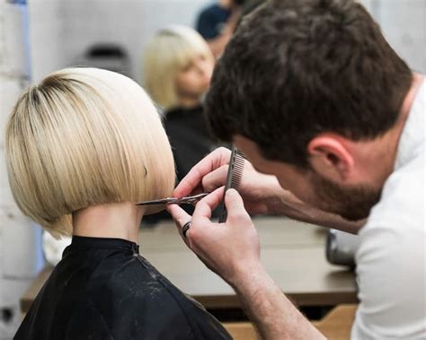 hairdresser cutting clients hair  salon  electric razor closeup central oklahoma college