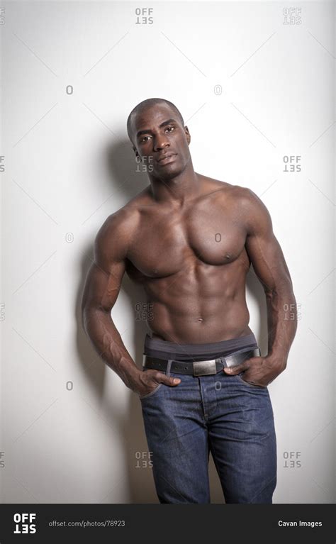 half naked african american man leaning against wall stock