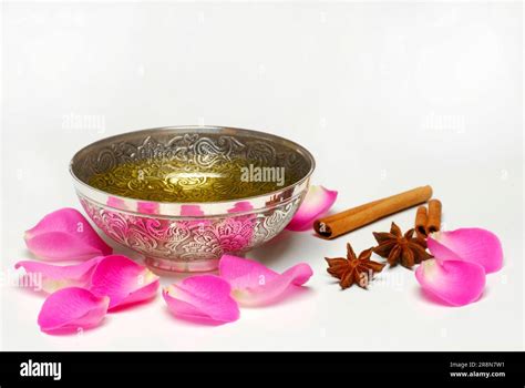 bowl  massage oil rose petals cinnamon sticks  star anise