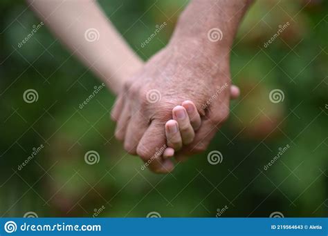 Granddaughter And Grandfather Hold Hands Close Up Stock Image Image