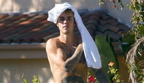 shirtless justin bieber shows off bulging biceps and toned abs justin