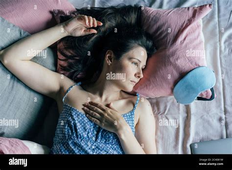 Authentic Portrait Of A Newly Awakened Young Woman Lying In Bed In