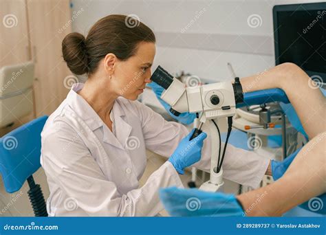 Female Gynecologist Examining Patient On Chair With Gynecological