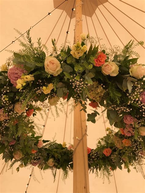 ring of flowers suspended in a marquee venue decoration wedding