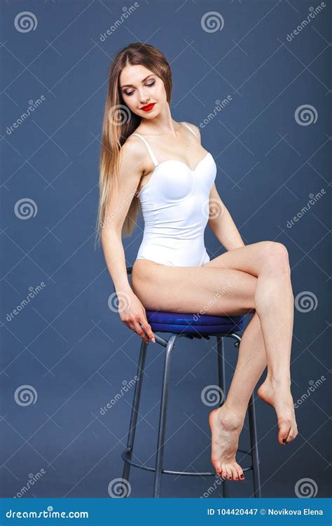 Stunning Women Sitting On A Bar Stool A Girl With Red Lipstick Posing