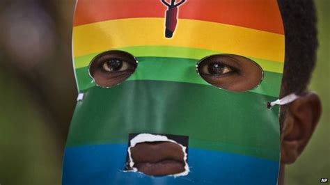 a kenyan gay man wears a mask to preserve his anonymity as he protests