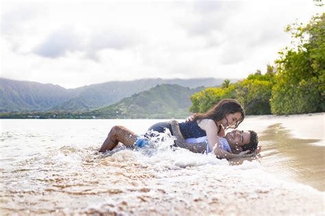 Couple Get Wet While Laying On The Sand Ans Water Crashes On … Hawaii
