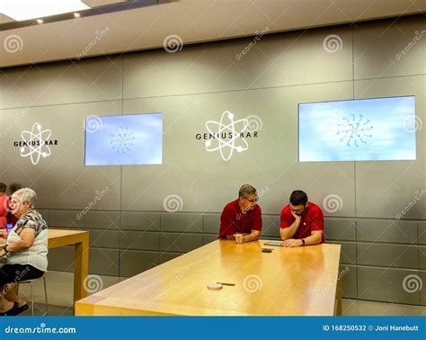 apple store employee helping  customer   issue      ipad
