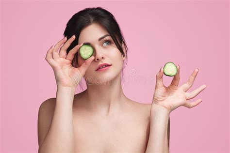 Young Woman Rubbing Cheeks With Cucumber Stock Image Image Of Lady
