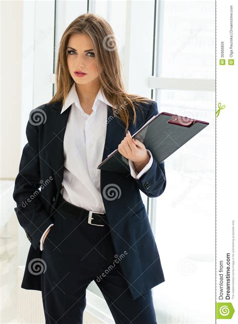 Businesswoman In Man S Suit And Shirt Writing With Pen At Her Office