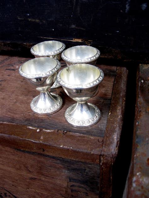 silver cups sitting  top   wooden box