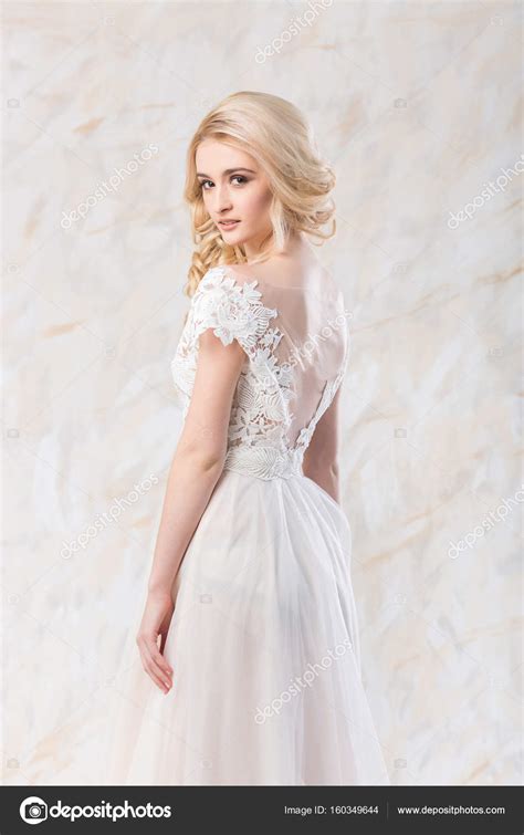 fashionable wedding dress beautiful blonde model bride hairstyle and makeup concept elegant