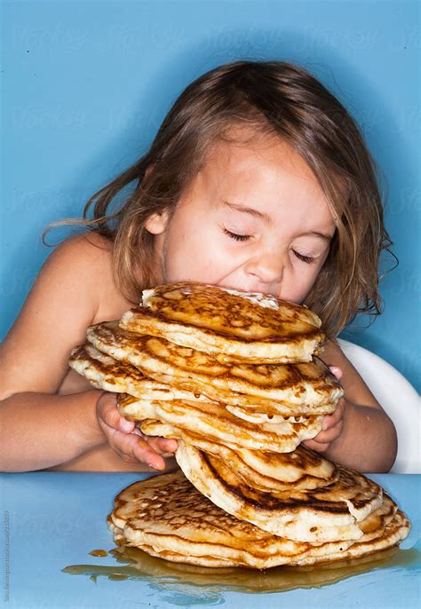 girl eats giant stack  pancakes  stocksy contributor sara remington stocksy