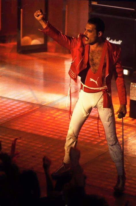 man  red jacket  white pants  stage   arms    side