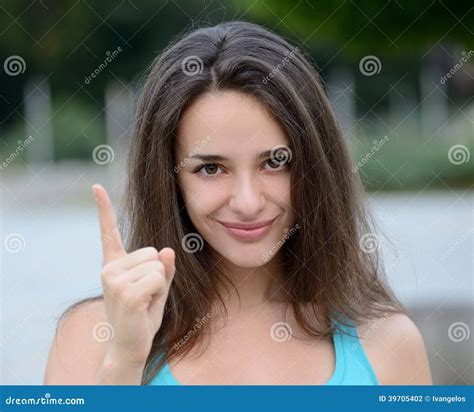 beautiful woman making warning hand sign stock photo image  brightly outdoors