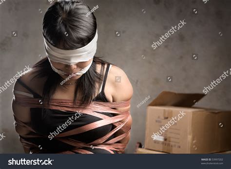 A Young Woman Tied Up Blind Folded And Muted In Old Room Low Key