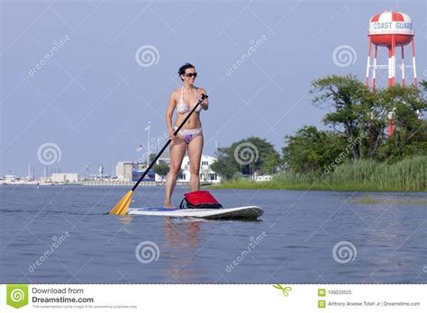 woman on a standing up paddleboard sup editorial image image of