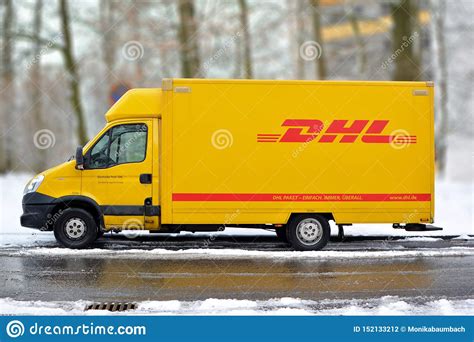 yellow dhl international courier  parcel deliivery service truck  snow editorial