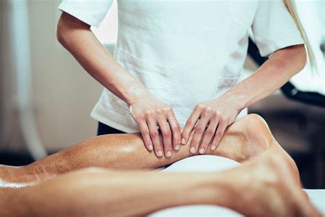 sports massage therapist massaging leg seasons salon