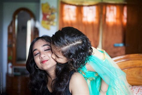 mother and daughter kissing and making fun inside home del