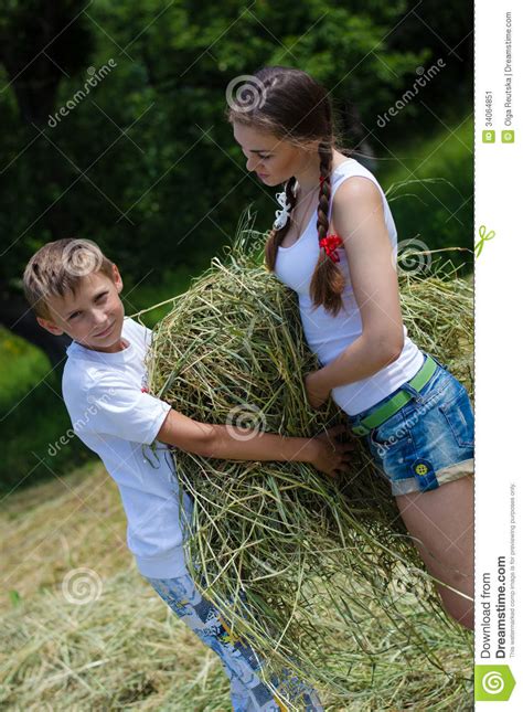 teenage sister and little brother holding velour grass or hay stock image image 34064851