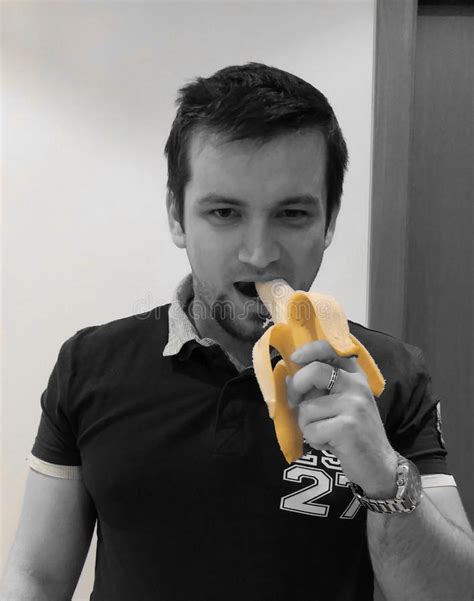man eating banana stock photo image