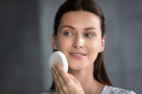 Head Shot Smiling Woman Cleaning Skin With Facial Cleansing Sponge