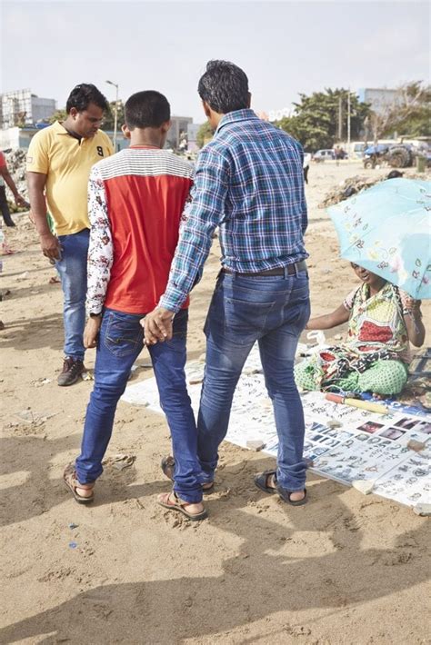 photographer captures  indian men hold hands