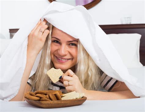 Female Secretly Eating Biscuits In Bed Stock Image Image