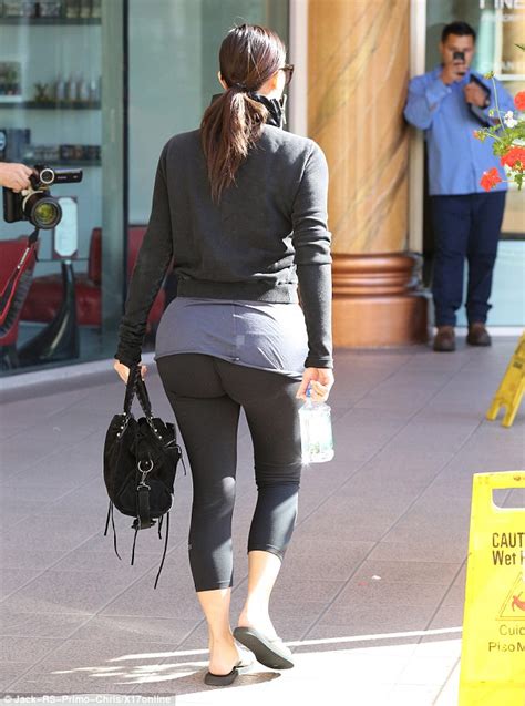 kim kardashian stretches her spandex to the limit as she covers her bottom for gym trip daily