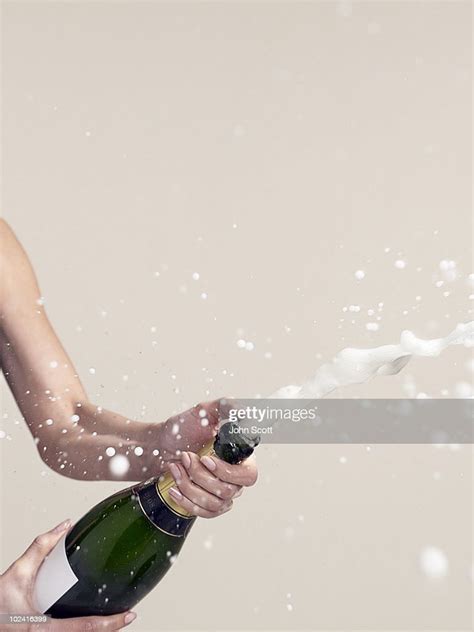 Woman Opening Champagne Bottle Photo Getty Images