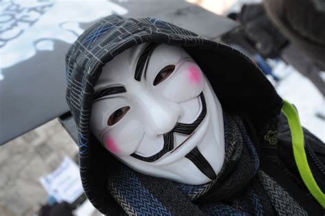anonymous protester wears mask abc news australian broadcasting