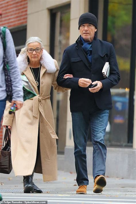 pierce brosnan plays doting son in law as he walks arm in arm with his wife keely s mother in
