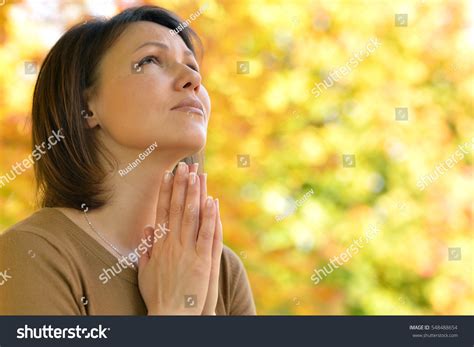 young woman praying stock photo  shutterstock