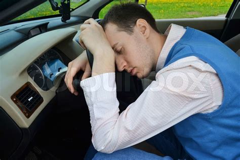 man sleeps in a car stock image colourbox