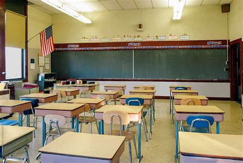 Elementary School Classroom Desls And Blackboard By Stocksy
