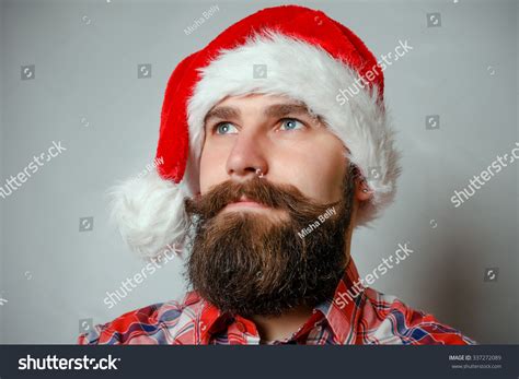 artistic portrait  gray haired santa claus santa white hat red
