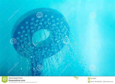 Modern Hot Shower With Stream Of Water Close Up On A Blue