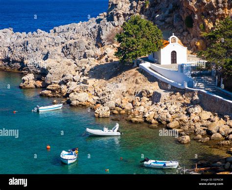 Tiny Church And Boats At St Pauls Bay Lindos Rhodes Greece Europe Stock