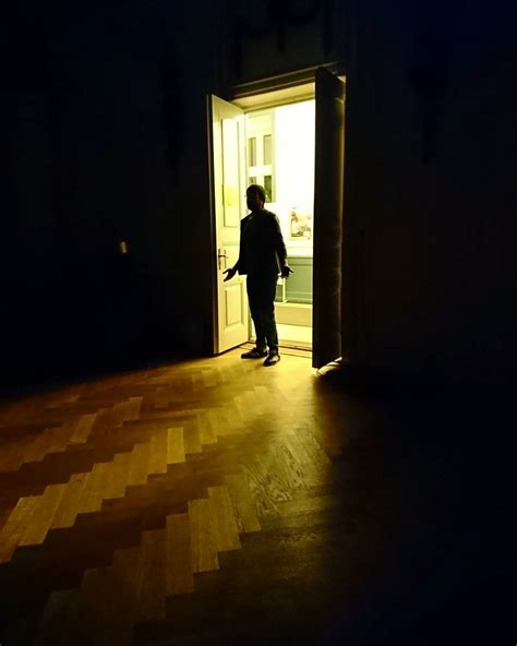 man entering room photo  flooring image  unsplash