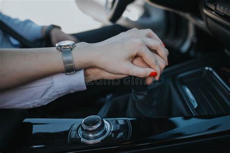 Romantic Couple Holding Hands On A Gear Shift While Driving A Car Stock