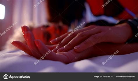 two lesbiens women are having sex in bedroom closeup of touching hands