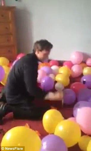 video shows a man taking on challenge of popping hundreds of balloons