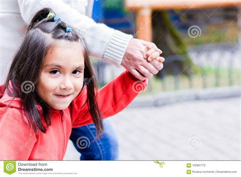 happy little latin girl and her grandmother holding hands