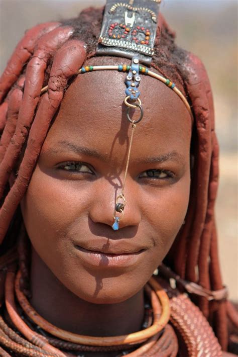 A Young Himba Girl Smiles For A Photo In Northern Namibia Near The